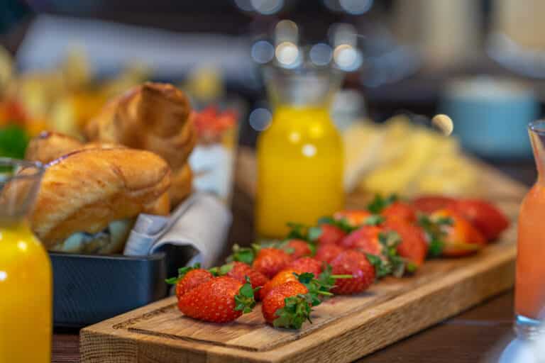Breakfast buffet served with, orange juice, croissants and strawberry